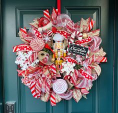 a christmas wreath with candy canes, candies and a nutcracker on it