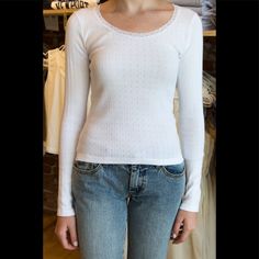 Ribbed Long Sleeve Eyelet Top With Lace Detailing On The Neckline. Fabrics: 100% Cotton Measurement: 21" (53 Cm) Length, 16" (41 Cm) Bust Made In: Italy Fitted White Pointelle Knit Blouse, Tops Brandy Melville, Eyelet Top, Brandy Melville Tops, Brandy Melville, Lace Detail, Brandy, Lace Top, In Italy