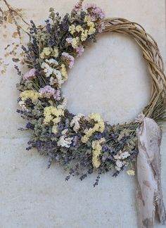 a wreath with dried flowers is on the ground