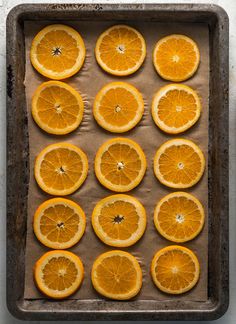 orange slices are arranged on a baking sheet