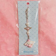 a key chain with an elephant and heart charm on it's end is packaged in a package