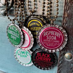 six different flavored soda bottle caps hanging from a door