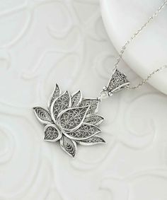 Introducing our stunning handcrafted filigree art lotus flower pendant necklace, perfect for adding a touch of elegance and sophistication to any outfit. The intricate detailing of the lotus flower, a symbol of purity and enlightenment, is showcased beautifully in this piece. Made with 925 sterling silver, the pendant's height is 1.70 inches and its width is 1.20 inches, with a 20-inch silver chain. It also comes with a silver polish cloth and luxurious gift box, making it an ideal gift for Moth Spiritual Filigree Flower Pendant Necklace, Elegant Lotus Flower Jewelry Gift, Spiritual Necklace With Flower Pendant And Intricate Design, Bohemian Jewelry With Intricate Flower Pendant, Delicate Silver Necklace For Meditation, Bohemian Jewelry With Intricate Flower Design, Bohemian Filigree Flower Pendant Jewelry, Bohemian Filigree Flower Pendant Necklace, Bohemian Flower Jewelry With Intricate Design