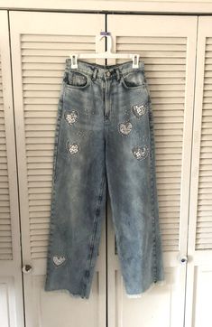 "These are stonewashed jeans made in Argentina. I have cut out hearts and embellished behind the hearts with white lace and sewn on pearl beads. They have frayed edge hems and 5 pockets. Good quality, never worn jeans. Better to wash on sensitive and hang dry. Please check sizing, label says size 28 which is like an 8 I think.  Very High rise. Waist is 28 \" Inside leg 29 \" Legs are quite wide about 10 \" I will ship in a day." Beaded Jeans, Cut Out Jeans, Stonewashed Jeans, Cable Knit Headband, Vintage Wrangler Jeans, High Waisted Jeans Vintage, Worn Jeans, Blue Denim Shirt, Blue Shirt Dress