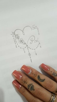 a woman's hand with some tattoos on her fingers and an i love you sign