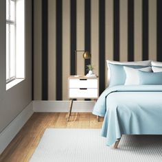 a bedroom with black and white stripes on the walls, bedding and nightstands