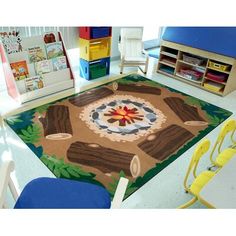 a child's play area with toys and books on the floor in front of it