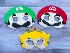 three masks with mario and luigi on them