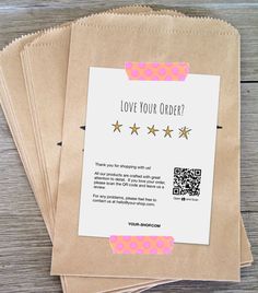 three brown bags with pink and white designs on them, one has a qr code for love your order