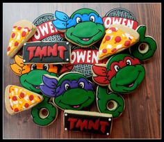 decorated cookies with teenage mutant pizzas and tmnt on them are sitting on a table