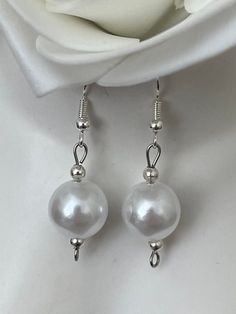 Ivory Pearl drop earrings. Add a touch of elegance to your wardrobe with these timeless dangle drop earrings. Handmade with love to elevate any look. Sterling silver ear hook with faux pearl drop. Free shipping to UK buyers. Dispatched within 1-3 days but I aim to post by the following day.  Presented on a gift card and wrapped beautifully in luxury tissue paper and a blush pink organza bag making them the perfect gifts for loved ones.  If you aren't completely in LOVE with your purchase, please let me know and you'll receive a stress free refund. Customer satisfaction is my main priority.  These are perfect for any occasion, weddings, brides, bridesmaids or gifts.  Thank you for viewing. Please ask any questions, I am always available to help. I have many pieces available in my shop, plea Quick Gifts, Ivory Pearl, Bridal Bracelet, Bridal Pearls, Ear Hook, Matching Bracelets, Earrings Sterling Silver, Pearl Drop Earrings, Pearl Drop