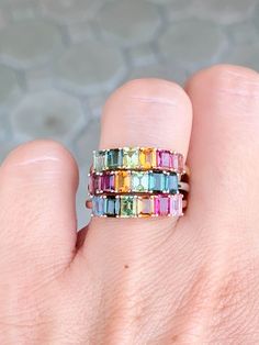 Add a splash of color and playful style to your everyday look with this 14K gold Rainbow Tourmaline Stacking Band. Perfect for layering, this unique and eye-catching band adds a vibrant touch to any outfit! Dare to make a fashion statement and become the envy of all your friends! ♥ The overall setting measures 17.8 mm in width, 4.3 mm in length, and sits 3.3 mm tall, band width is 1.7 mm ♥ We have 3 rings in stock. What you see is what you will receive! ♥ Ring Size: US 7 (Free resizing up or down one size) ♥ Material: 14K Gold ♥ Gemstone: Tourmaline, between 1.3-1.5ct total for each ring ♥ Free shipping in the US.  ♥ This is in stock and ready to ship right away! ▶▶ Sign up for our newsletter to receive a 10% off coupon for purchases from our website: https://www.auroradesigner.com/pages/n Multicolor Emerald Cut Fine Jewelry Rings, Multicolor Stackable Sapphire Ring Fine Jewelry, Multicolor Sapphire Ring For Wedding, Multicolor Multi-stone Emerald Cut Rings, Multicolor Sapphire Ring In 14k Gold, Multicolor Emerald Cut Multi-stone Rings, Multicolor Baguette Cut Fine Jewelry Rings, Multicolor Sapphire Ring In 14k Gold For Wedding, Multicolor Emerald Cut Gemstone Rings