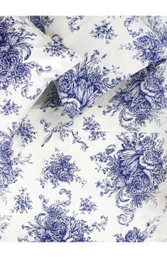 the blue and white floral print on this bed sheet is very feminine, but it doesn't look like they are