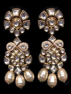 Due to the current situation, this product will be shipped after 3-4 weeks from the date of the placement of the order. Kundan work inspired Indian earrings with high graded shell pearls. Earrings based in silver and copper alloy and embellished with faux glass polki.  Wear this with almost anything Indian for a rich and royal look because nothing more regal than kundan earrings. Details: Handcrafted Metal: Gold Plated Stone: Shell Pearls Semi Precious Kundan Dimensions: Length 3.5 inches / Widt Elegant Metal Chandbali Bridal Earrings, Elegant Chandbali Bridal Earrings In Metal, Elegant Kundan Pearl Earrings For Celebration, Elegant Hand Set Pearl Earrings For Festive Occasions, Elegant Kundan Drop Danglers, Kundan Pearl Earrings With Stone Work For Celebrations, Elegant Metal Chandbali Earrings, Elegant Kundan Drop Earrings, Elegant Kundan Pearl Earrings For Festive Occasions