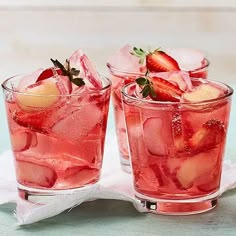 three glasses filled with ice and strawberries