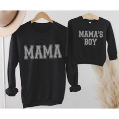 The Cutest matching Mommy and Son shirts.  Mama and Mama's Boy t-shirt or sweatshirt in 3 Colors. Soft and Comfy our Unisex Sized Sweatshirts are sure to be a favorite.   TO PLACE YOUR ORDER: 1. Select your size/style and color from the drop down menus 2. Enter Mama and Mama's Boy Color Preference in Personalization Section: Black, White, Charcoal Gray 3. Click Add to Cart, then go back and repeat for each shirt. Please see images for sizing details. Please measure your current sweatshirts that Family Matching Graphic Print Sweatshirt, Black Long Sleeve Sweatshirt With Name Print, Family Matching Black Sweatshirt For Winter, Family Matching Black Winter Sweatshirt, Black Family Matching Tops For Winter, Long Sleeve Tops With Letter Print, Family Matching Crew Neck Sweatshirt With Graphic Print, Cotton Top With Name Print For Winter, Winter Cotton Top With Name Print