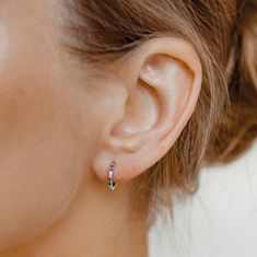 Small huggie hoop earrings, handmade from 925 sterling silver. Decorated with 9 tiny colored stones, set along their front edge, all in a vertical row. The colors of the stones include red, blue, green, white, and yellow, and the pattern in which they are placed is the same on both earrings. Delicate, elegant and unique, these earrings will instantly brighten up any outfit, be it casual or formal-wear. → Inner diameter: 9.6 mm, weight: 1.5 g → Available in silver and gold. The golden hoop earrin Sterling Silver Huggie Earrings With Birthstone, Multicolor Huggie Earrings For Gift, Multicolor Huggie Earrings As Gift, Huggie Earrings Silver, Colorful Stones, Earrings Colorful, Huggie Earrings, 925 Silver Jewelry, Huggie Hoop Earrings