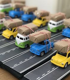 toy cars are lined up on the road with boxes tied to them's backs