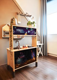 a wooden shelf with an advertisement on it in front of a window next to a sink