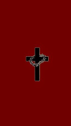 a black cross on a red background with a chain hanging from it's center