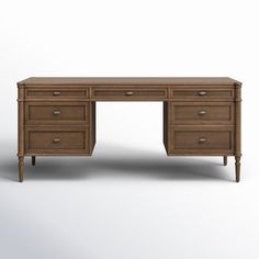 Influenced by vintage European lines, this inspired desk is elegant and full of presence. Framed panels, rounded corners and finished with aged brass drawer pulls and tapered spindle legs for warm character. Made from solid oak and veneer in distressed black for a classic look. Color: Toasted Oak Birch Lane™ Susie Executive desk - Desks in Toasted Oak | Size 31" H X 70" W X 27" D Brass Drawer Pulls, Vintage European, Executive Desk, Four Hands, European Vintage, Birch Lane, Aged Brass, Round Corner, Toulouse