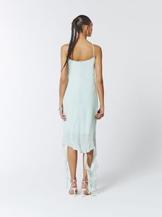 This fluid semi-sheer midi dress is an edgy piece with an asymmetrical hem and delicate ruffle trims. It features spaghetti straps and a hidden back zipper closure.  Semi-sheer fabric Lined Asymmetrical hem Ruffle trims Zip fastening at back  Fits true to size, take your normal size Model is 5'9" / 174cm and wears a size UK6 (US2 / EU34) Main: 100% Polyester Lining: 100% Polyester  Dry Clean Only Turn inside out before cleaning Do not tumble dry Iron on low heat, maximum 110 °C Do not bleach  Fa Summer Daywear Midi-length Ruffle Dress, Summer Midi Ruffle Dress For Daywear, Fitted Ruffle Midi Dress For Daywear, Fitted High-low Midi Dress For Summer, Evening High Low Dress For Spring, Chic Asymmetrical Maxi Dress With Ruffles, Evening Maxi Dress With Asymmetrical Ruffle Hem, Fitted Midi Length Ruffle Dress For Summer, Chic Fitted High Low Spring Dress