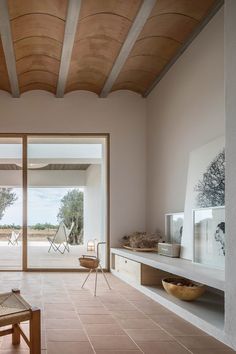 a living room filled with lots of furniture and decor on top of tile flooring