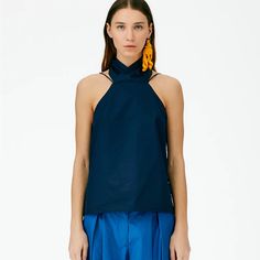 This Eco Poplin Halter Top Crafted In Certified Organic Cotton Is Double Strapped To Emphasize Versatility And Styling Options Focused On Personal Preference. Equal Parts Creative And Pragmatic, This Halter Pairs Back Just As Well To The Cotton Drill Slouchy Carpenter Jean As It Does To The Lean Back Skirt. 100% Cotton Blue Poplin Tops For Work, Blue Poplin Tops For Workwear, Modern Poplin Tops For Spring, Elegant Summer Poplin Tops, Summer Poplin Blouse, Poplin Blouse For Summer, Modern Blue Summer Blouse, Modern Blue Blouse For Summer, Lean Back