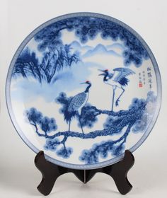 a blue and white plate with two birds on it