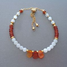 ~ ♦ ~ Moonstone & Carnelian Beaded Bracelet ~ ♦ ~ Details: * 6x8mm Carnelian Teardrop * 3x4mm Carnelian rondel * 4mm smooth Moonstone rounds * Gold plated spacers * Choice of Slider clasp - fits most wrists - or lobster clasp with extender chain ★ Carnelian restores vitality, motivation, and stimulates creativity. It promotes courage, security, and safety. ★ Moonstone is a beautiful crystal with a magical energy that brings emotional stability, hope, and balance. It's associated with the Crown a Adjustable Carnelian Beaded Bracelets With Gemstone Beads, Adjustable Carnelian Gemstone Beaded Bracelets, Adjustable Carnelian Gemstone Beaded Bracelet, Adjustable Carnelian Beaded Bracelets, Carnelian Beaded Bracelets With Gemstones, Carnelian Gemstone Beaded Bracelets, Carnelian Beaded Bracelets With Natural Stones As Gift, Bohemian Carnelian Gemstone Beaded Bracelets, Adjustable Carnelian Beaded Bracelet For Healing