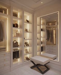 a walk in closet filled with lots of white furniture