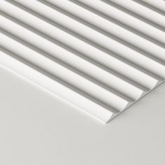 a close up view of the top of a white blinds