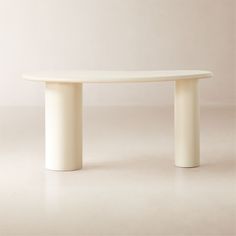 a white table with two curved legs and a circular top on the bottom, in front of a plain background