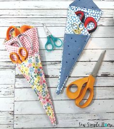 some scissors are laying next to an origami umbrella and other crafting supplies