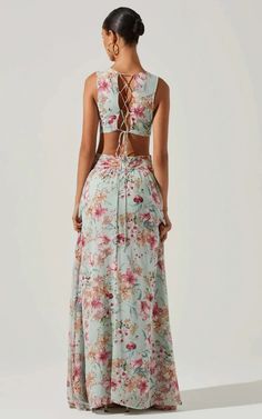 The Noya Dress features a floral print throughout. Plunging neckline leads to a cross front waist with cutout details. Ruffle maxi skirt. Lace up back. Concealed back zip closure. SIZE + FITLength: 59"Model is wearing size SModel height is 5'8"Size S:Bust 28 1/2" DETAILS + CAREDry clean onlySelf: Self 100% Polyester Lining 100% PolyesterCutout detailZipper closure فستان زهري, Ruffle Maxi Skirt, Flora Dress, Cutout Maxi Dress, Aqua Dress, Maxi Dress Green, Ruffled Maxi Dress, Daily Dress, Maxi Dress Blue