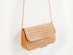 This straw clutch bag for women is a small crossbody purse for any occasion: holiday, evening, wedding, going out. Natural raffia bag will make you image complete. The straw bag is handmade using the technique of weaving on plastic canvas. It has a tight frame, keeps its shape well.  DETAILS:- thread is 100% raffia- length 18cm/7 in, height 11cm/4 in, width 5.5cm/2 in- removable chain handle: 118cm/46 in- color – beige- 100% silk lining (sewn by an invisible stitch manually) with inside pocket- Beach Crossbody Clutch With Adjustable Strap, Elegant Woven Natural Straw Bag, Summer Vacation Shoulder Bag Clutch, Elegant Natural Woven Straw Bag, Beige Crossbody Clutch For Vacation, Summer Vacation Clutch, Evening Rectangular Straw Bag With Adjustable Strap, Beige Crossbody Clutch For Beach, Elegant Natural Straw Bag