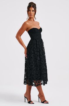 Fall in love with delicate lace in the Ishani dress, an elegant midi with strapless corset bodice which has boning and lace up back for a super cinched waist. The all-over lace design is fully lined and has tulle in the skirt for extra volume. Wear her with soft waves, glowy makeup and clear mule heels. 



Colour: Black.

Premium floral lace fabric.

Fully lined.

Underwired bust.

Boning in bodice.

Tulle in skirt for volume.

Lace up back for cinched waist.

Invisible zipper to side.

Midi le Formal Midi Dress With Lace Bodice, Formal Dresses With Corset Back, Midi Length, Formal Dresses With Corset Back And Midi Length, Formal Midi Dress With Corset Back, Elegant Midi Dress With Lace Bodice, Formal Lace Dress With Fitted Bodice And Midi Length, Elegant Spring Midi Dress With Corset Back, Midi Dress With Corset Back For Date Night, Elegant Lace Tea-length Midi Dress