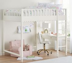 a child's bedroom with a loft bed, desk and chair