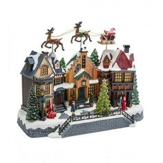 a christmas village is shown with santa's sleigh and reindeer on the roof