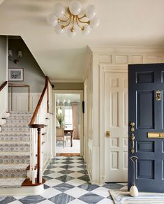 an entry way with blue doors and checkered flooring on the ground, stairs leading up to another room