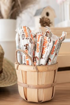 a basket filled with candy sitting on top of a wooden table