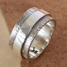 two silver rings sitting on top of each other