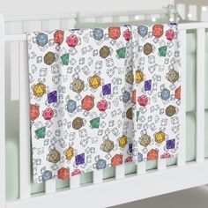 a crib rail cover with colorful dices on it