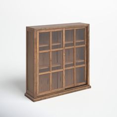 a wooden bookcase with glass doors on the front and bottom, against a white background