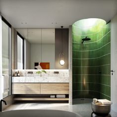 a bathroom with a tub, sink and green tiled wall behind the bathtub is a large mirror