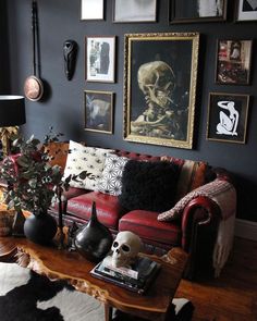 a living room filled with furniture and pictures on the wall