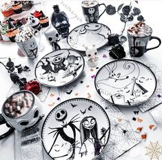 a table topped with plates covered in halloween decorations