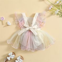 Dress your little one in colorful charm with our Spring Ruffles Bowknot Dress! This delightful ensemble combines the sweetness of floral patterns with the vibrancy of rainbow pastel ruffles for a fun and playful look. Adorned with a charming bowknot, it adds a touch of elegance to the outfit. Material: Cotton, tulle Bowknot Dress, Bow Decor, Comfy Dresses, Cute Rompers, 1st Birthday Girls, Romper Dress, Girls Rompers, Romper With Skirt