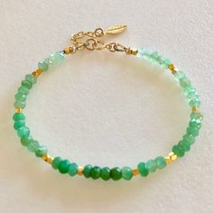 "Lovely natural green chrysoprase gemstone beaded bracelet with 24k gold vermeil accents. Beautiful Australian chrysoprase gems are 4mm faceted rondelles in luscious shades of light to darker apple green. 2mm faceted 24k solid gold vermeil cubes add sparkling accents. Made to order on professional beading wire with 14k gold fill spring ring clasp and findings. A little 22k gold vermeil leaf charm dangles from 1\" extension. Also available in .925 Sterling silver." Green Gemstone Rondelle Beaded Bracelets, Green Rondelle Beaded Spiritual Bracelets, Green Spiritual Rondelle Beaded Bracelets, Green Rondelle Beaded Bracelets With Faceted Beads, Green Rondelle Bracelets With Faceted Beads, Green Rondelle Bracelets For Jewelry Making, Green Onyx Beaded Bracelets As Gift, Handmade Gold Aventurine Beaded Bracelets, Green Amazonite Round Bead Bracelets