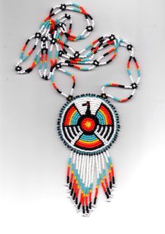 a beaded necklace with an orange, red and blue design on it's side